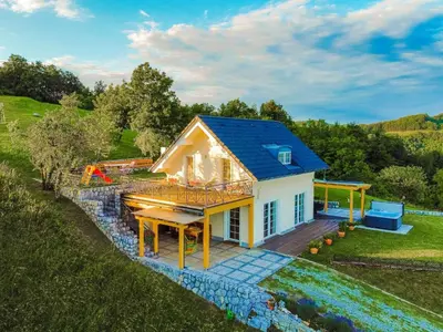 a small house with a deck and a table at Secluded Escape Hilltop Villa with Hot-Tub - Two Bedroom Villa with Hot-Tub
