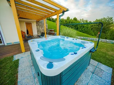 a hot tub in a backyard with a pergola at Secluded Escape Hilltop Villa with Hot-Tub - Two Bedroom Villa with Hot-Tub