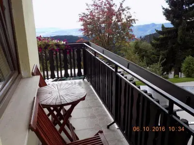 a balcony with a table and a chair on it at Comfortable Zre e Apartment - One Bedroom Apartment in Zreče