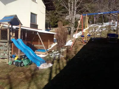 a playground in a yard with a slide at Comfortable Zre e Apartment - One Bedroom Apartment in Zreče