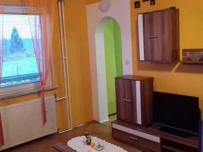 a living room with a tv and a room with a window at Comfortable Zre e Apartment - One Bedroom Apartment in Zreče