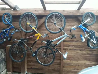 three bikes are hanging on a wall at Comfortable Zre e Apartment - One Bedroom Apartment in Zreče