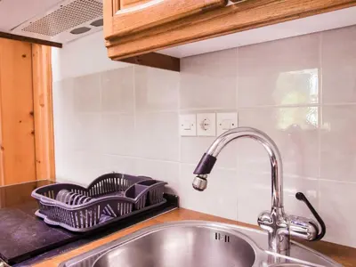 a kitchen sink with a dish drying rack on it at Rustic Authentic Holiday Home with Terrace and Wood Stove - Three Bedroom Holiday Home with Terrace in Ljubno
