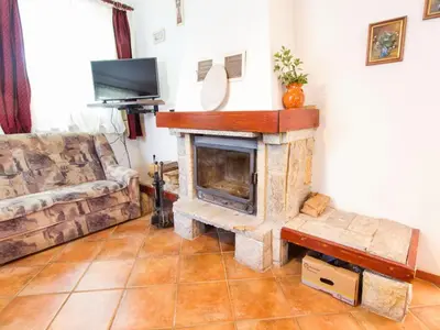 a living room with a fireplace and a couch at Rustic Charm Cottage Country House with Sauna - Five Bedroom Holiday Home with Sauna in Bizeljsko