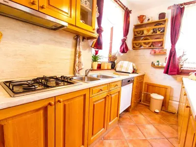 a kitchen with a sink and a stove at Rustic Charm Cottage Country House with Sauna - Five Bedroom Holiday Home with Sauna in Bizeljsko
