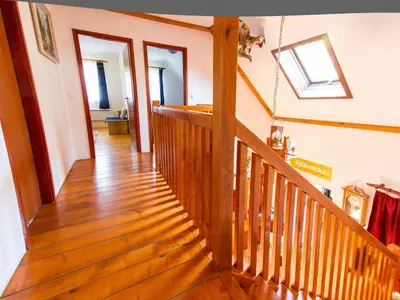 a wooden staircase in a home with a skylight at Rustic Charm Cottage Country House with Sauna - Five Bedroom Holiday Home with Sauna in Bizeljsko
