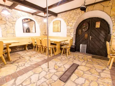 a dining room with a wooden table and chairs at Rustic Charm Cottage Country House with Sauna - Five Bedroom Holiday Home with Sauna in Bizeljsko