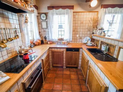 a large kitchen with wooden counters and a sink at Cozy Countryside Retreat Villa with Hot-Tub - Two Bedroom Villa with Hot Tub
