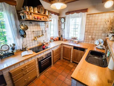 a large kitchen with wooden cabinets and a sink at Cozy Countryside Retreat Villa with Hot-Tub - Two Bedroom Villa with Hot Tub