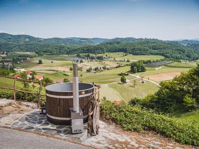 a barrel sitting on the side of a hill with a view at Cozy Countryside Retreat Villa with Hot-Tub - Two Bedroom Villa with Hot Tub