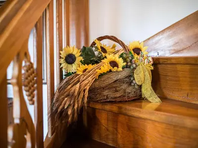 a basket filled with sunflowers sitting on a stair case at Cozy Countryside Retreat Villa with Hot-Tub - Two Bedroom Villa with Hot Tub