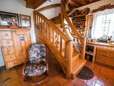 a room with a wooden staircase and a chair at Cozy Countryside Retreat Villa with Hot-Tub - Two Bedroom Villa with Hot Tub