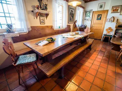 a dining room with a wooden table and a bench at Cozy Countryside Retreat Villa with Hot-Tub - Two Bedroom Villa with Hot Tub