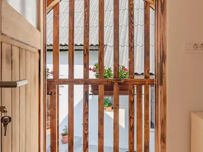 a wooden door with a potted plant in a room at Nature Hideaway Holiday Homes with Sauna - One Bedroom Holiday Home in Slappe dʼIdria