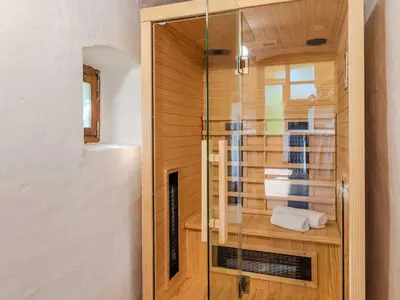 a shower with a glass door in a bathroom at Nature Hideaway Holiday Homes with Sauna - One Bedroom Holiday Home in Slappe dʼIdria