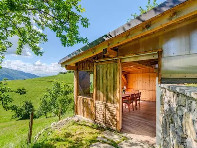 a wooden house with a table on a deck at Nature Hideaway Holiday Homes with Sauna - One Bedroom Holiday Home in Slappe dʼIdria