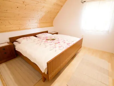 a bedroom with a large bed in a room at Sunny Two Bedroom Retreat in Beautiful Bizeljsko - Two Bedroom Country House in Bizeljsko