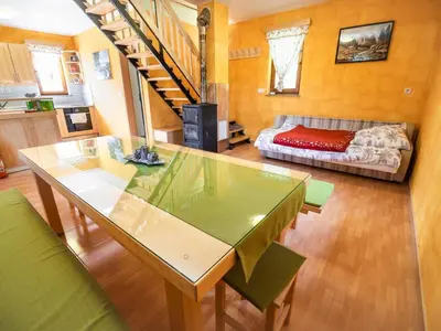 a living room with a table and a couch at One Bedroom Holiday Home with Terrace and Garden in Krška Vas