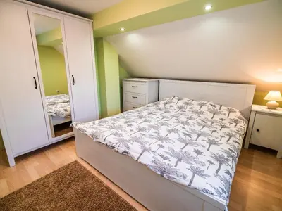 a bedroom with a bed and a dresser and a mirror at One Bedroom Holiday Home with Terrace and Garden in Krška Vas