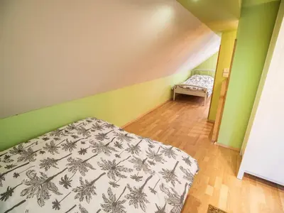a bedroom with a bed and a bench in a room at One Bedroom Holiday Home with Terrace and Garden in Krška Vas