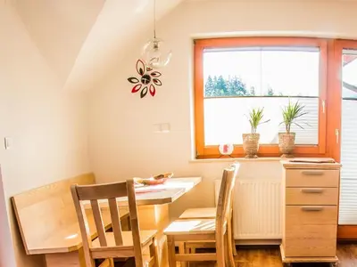 a dining room with a table and chairs and a window at Riverside Pines Luce Apartments with Balcony - Studio Apartment with Balcony in Luče