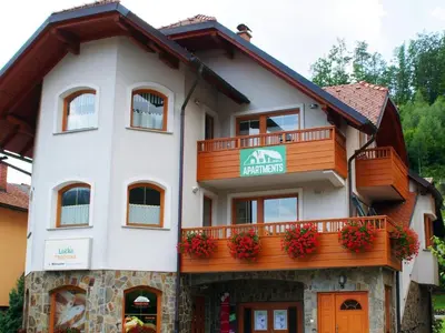 an apartment building with a balcony and flowers on it at Riverside Pines Luce Apartments with Balcony - Studio Apartment with Balcony in Luče