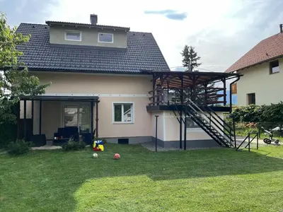 a house with a spiral staircase in the yard at Meadow Tranquil Apartments with Evergreen Garden - One Bedroom Apartment in Žirovnica