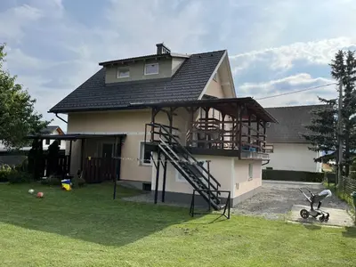 a house with a playground in front of it at Meadow Tranquil Apartments with Evergreen Garden - One Bedroom Apartment in Žirovnica