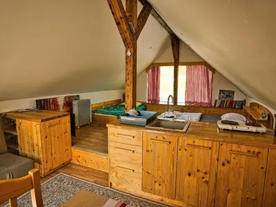 a kitchen with wooden cabinets and a sink in a attic at Visnja Gora Meadow Hideaway with Terrace - One Bedroom Cottage with Terrace in Višnja Gora