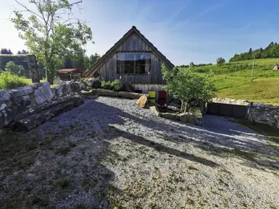 a barn with a gravel driveway in front of it at Visnja Gora Meadow Hideaway with Terrace - One Bedroom Cottage with Terrace in Višnja Gora