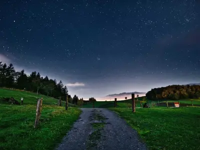 a road in a field at night with a starry sky at Visnja Gora Meadow Hideaway with Terrace - One Bedroom Cottage with Terrace in Višnja Gora