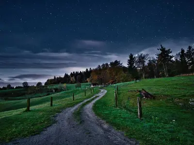 a dirt road in a field at night at Visnja Gora Meadow Hideaway with Terrace - One Bedroom Cottage with Terrace in Višnja Gora