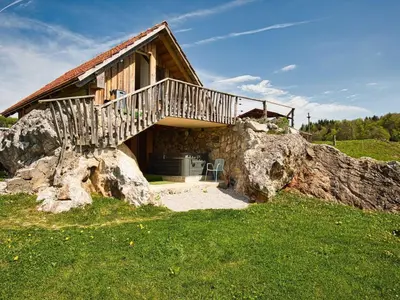 a cabin on top of a large rock at Visnja Gora Meadow Hideaway with Terrace - One Bedroom Cottage with Terrace in Višnja Gora