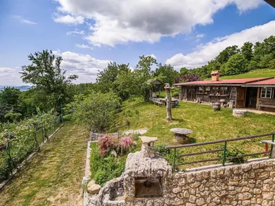 an estate with a stone wall and a house at Hidden Authentic Haven Apartments - Two Bedroom Apartment with Balcony in Sevnica