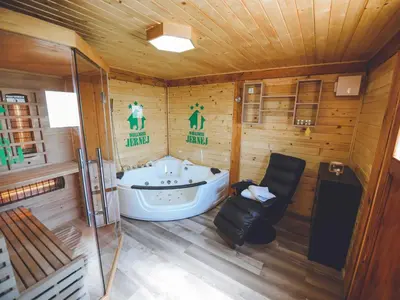 a bathroom with a tub in a wooden cabin at Relax and Rustic Apartments with Terrace - Classic One Bedroom Apartment with Terrace in Brežice