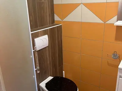a bathroom with a toilet with a black seat at Meadow Tranquil Apartments with Evergreen Garden - Two Bedroom Apartment in Žirovnica