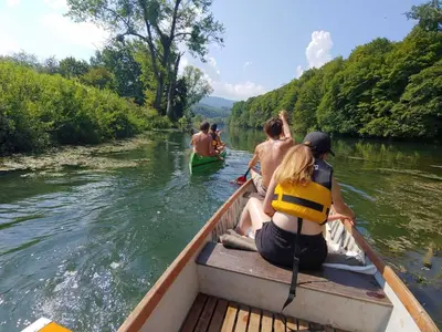 a group of people in a boat on a river at Cozy Luxe Holiday Home with Natural Thermal Bath - Seven Bedroom Holiday Home in Cerklje ob Krki
