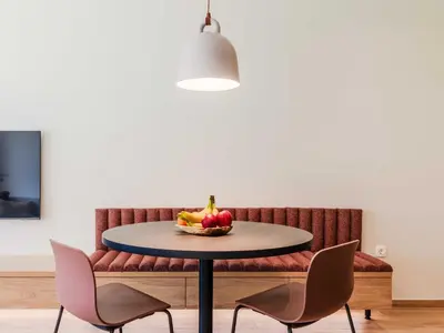 a table with a bowl of fruit on it in front of a couch at Bovec Chic Apartment with Sauna - One Bedroom Apartment with Balcony in Bovec