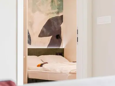a room with two beds and a painting on the wall at Bovec Chic Apartment with Sauna - One Bedroom Apartment with Balcony in Bovec