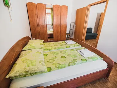 a bedroom with a bed and a mirror at Bovec Picturesque Mountain Vista Residences - One Bedroom Apartment in Bovec