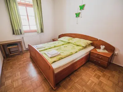 a bedroom with a wooden bed with a wooden floor at Bovec Picturesque Mountain Vista Residences - One Bedroom Apartment in Bovec