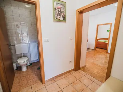 a bathroom with a toilet in a room at Bovec Picturesque Mountain Vista Residences - One Bedroom Apartment in Bovec