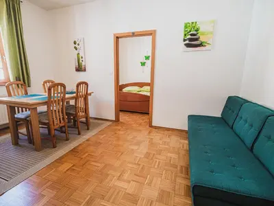 a living room with a couch and a table at Bovec Picturesque Mountain Vista Residences - One Bedroom Apartment in Bovec