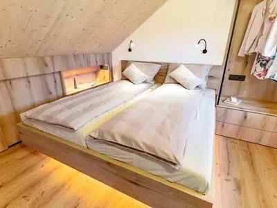a bedroom with a large bed in a room at Elegant Warm Bliss Hideaway Escape Lodge - Holiday Home with Hot-Tub and Sauna in Šenčur