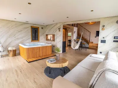 a living room with a tub and a table at Elegant Warm Bliss Hideaway Escape Lodge - Holiday Home with Hot-Tub and Sauna in Šenčur
