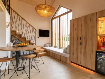 a living room with a table and chairs and a window at Elegant Warm Bliss Hideaway Escape Lodge - Holiday Home with Hot-Tub and Sauna in Šenčur