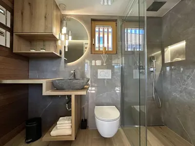 a bathroom with a sink and a toilet and a shower at Elegant Warm Bliss Hideaway Escape Lodge - Holiday Home with Hot-Tub and Sauna in Šenčur