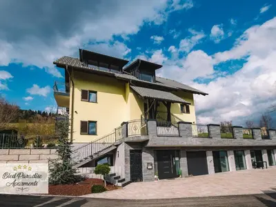 a large yellow building with balconies on it at Bled Prestigious and Stylish Apartments - Standard One Bedroom Apartment with Balcony in Bled