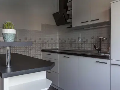 a kitchen with white cabinets and a sink at Two Bedroom Apartment in Rečica ob Savinji