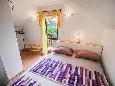 a bedroom with a large bed with a window at Harvest Horizon Holiday Home with Sauna - One Bedroom Holiday Home in Brežice